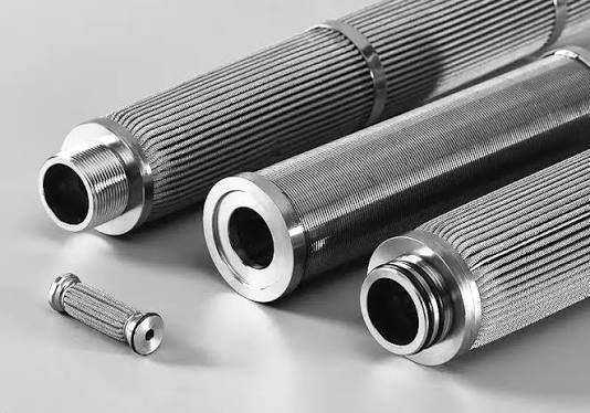 Custom sintered metal fiber felt filter element formed to a drawing — a pleated cartridge, cylinder, disc or custom shape — with a welded end connection